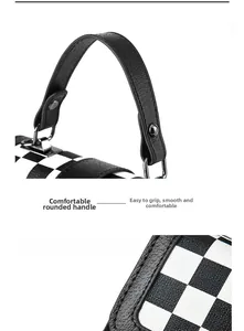 Detail of round leather handle and silver metal clasp on black checkered handbag