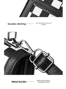 Close-up of houndstooth leather texture with sturdy stitching and dark silver hardware