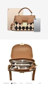 Detail view of brown leather crossbody bag with multiple interior pockets and dual compartments