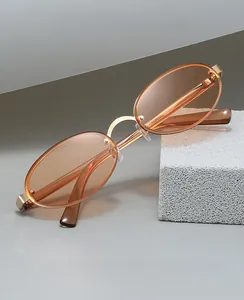 Detailed macro view of retro oval orange lenses with premium gold metal frame details