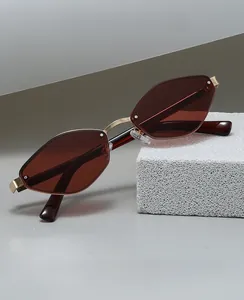 Close-up of polygon retro sunglasses with tea lenses and golden metal hinges