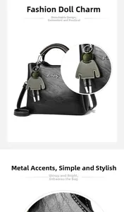 Detail of oil wax leather handbag with removable green charm and metal logo accents