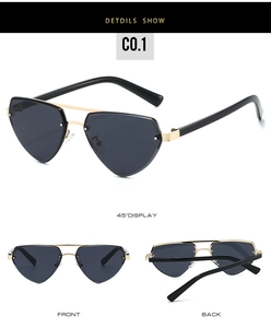 Détail de lunettes de soleil en forme de cœur avec double pont et rivets dorés