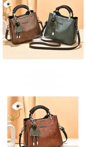 Detail shot of vintage oil wax leather texture on handbags with brand logo and doll charm