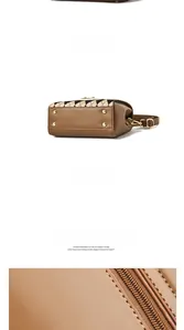 Detail of brown leather bag showing gold bottom studs and diamond quilted stitching