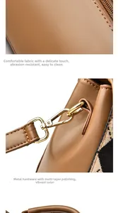 Detailed view of brown PU leather texture and polished golden metal buckle on square bag