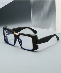 Detail view of black square chunky frames with gold U-shaped metal bridge accent