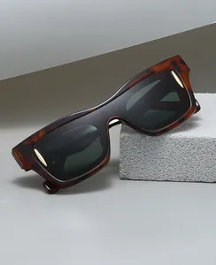 Macro shot of stylish tortoiseshell frames with golden arrow accents and blue light lenses