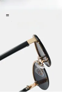 Detail of retro oval sunglasses with high-elasticity temples and golden metal bridge