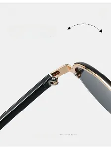 Close-up of durable golden metal hinge on vintage oval sunglasses with dark lenses