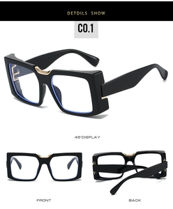 Detailed view of black square frame glasses featuring gold metal bridge and E-logo hinges