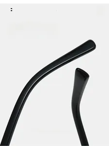Macro detail of the glossy black ergonomic curved temples on trendy polygon sunglasses