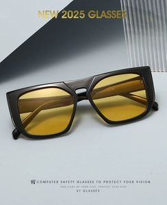 Detail view of square black frames with yellow lenses showing spec 13179 53-19-140