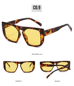Detail view of tortoiseshell flat top square sunglasses with yellow tinted lenses