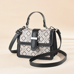 Vintage houndstooth pattern crossbody bag with contrasting black leather and silver buckle