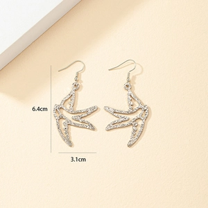 Detail view of silver swallow drop earrings showing hammered texture and 6.4cm height