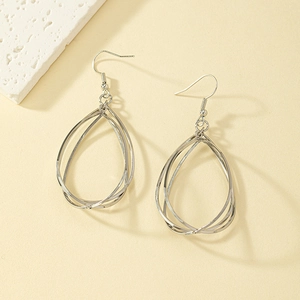 Detail of silver layered teardrop earrings with triple-nested polished metal rings