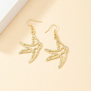 Elegant gold swallow drop earrings with textured hammered finish on minimalist background