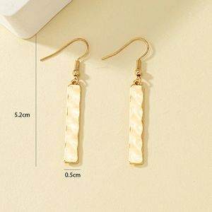 Minimalist gold long bar drop earrings with hammered texture measuring 5.2cm in length