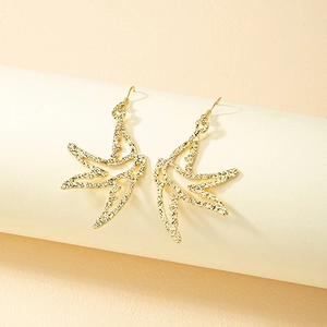 Golden swallow bird drop earrings with textured hammered finish and openwork design