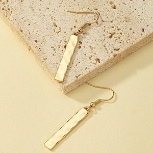 Minimalist gold bar drop earrings with hammered texture and classic fishhook back