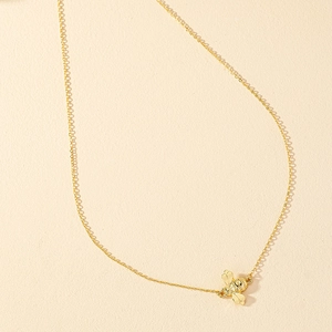 Elegant gold bee pendant necklace with textured wings on a minimalist fine metal chain