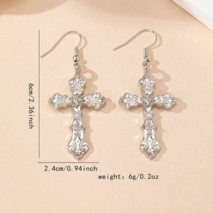 Silver gothic cross drop earrings with intricate baroque texture and radial patterns