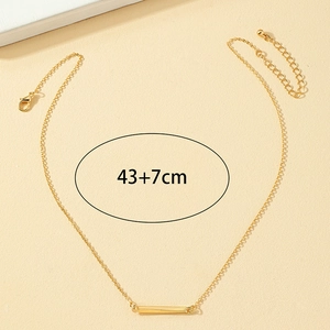 Minimalist gold geometric bar necklace with adjustable 43+7cm chain on sandy background