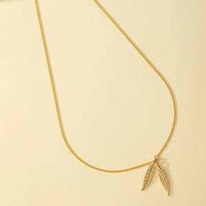 Elegant gold Y-shaped necklace featuring dual textured feather pendants on a fine chain