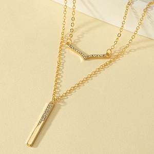 Double layered gold V-shape and bar necklace with shimmering rhinestones and thin chains
