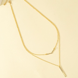 Double-layered gold V-shaped necklace with sparkling rhinestone pendants in tiered design