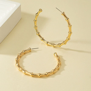 Minimalist golden bamboo joint C-shaped hoop earrings with bright metallic finish