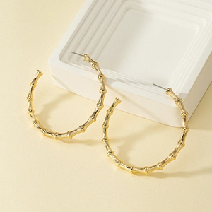 Golden bamboo joint C-shape hoop earrings with a polished finish and minimalist design