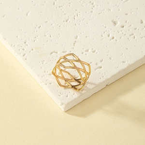 Minimalist gold hollow geometric ring with crossover mesh design on stone background