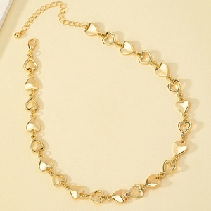 Minimalist gold heart necklace featuring hollow and solid linked charms in a circular layout