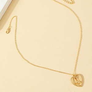 Golden heart snake necklace featuring an intricate hollow pendant on a fine link chain
