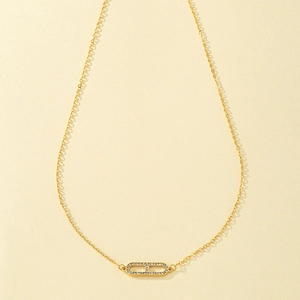 Elegant gold necklace with crystal-paved pill pendant on a simple cable chain