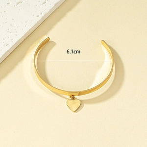 Minimalist gold open bangle with heart pendant and 6.1cm inner diameter measurement