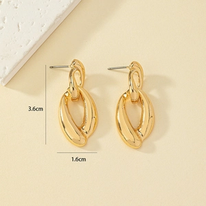 Detail view of gold alloy chain earrings with dimensions 3.6cm by 1.6cm on a stone base