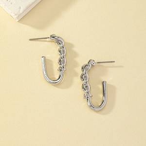 Detailed view of silver twisted U-shaped earrings with textured spiral design