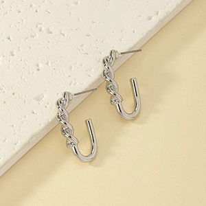 Elegant silver twisted rope earrings in J-shape design on minimalist display stand