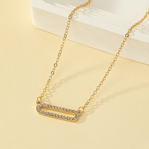 Minimalist gold geometric necklace featuring a sparkling crystal pave rectangular pendant