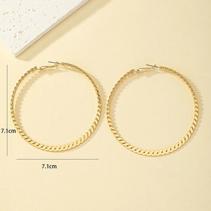 Detail view of 7.1cm gold-tone hoop earrings with a sophisticated twisted texture