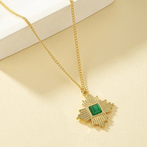 Vintage 18K gold necklace with green cat-eye stone pendant in geometric sunburst design