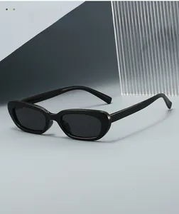 Classic black oval sunglasses with high-quality resin frames in a minimalist studio setting