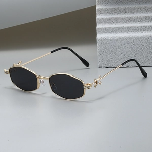 Polygonal gold metal sunglasses with dark hexagonal lenses and rhinestone details