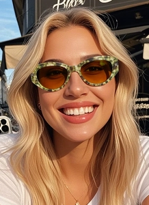 Detailed view of green marble pattern frame sunglasses with amber lenses on a model