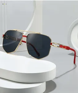 Detail of pilot sunglasses with gold metal frame and red decorative temple tips