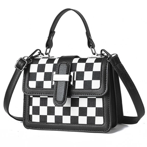 Modern black and white checkered crossbody handbag with leather trim and silver metal buckle