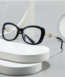 Detail view of large cat-eye glasses featuring golden hollow twisted metal temples